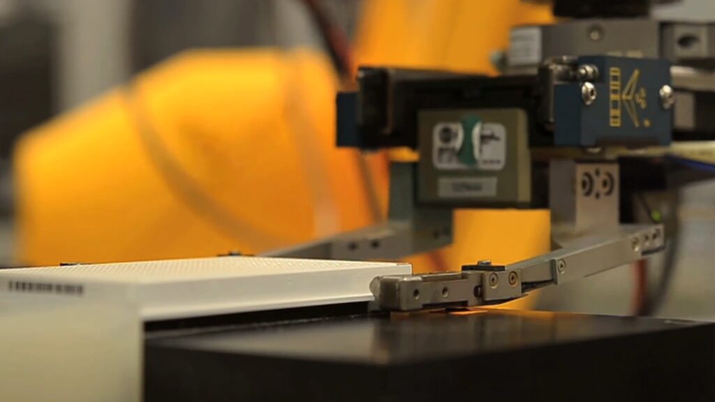 A robot arm handles an assay plate in high-throughput screening process. This image is from video titled "Using 3D Printing to Advance Science" created by NIAID.